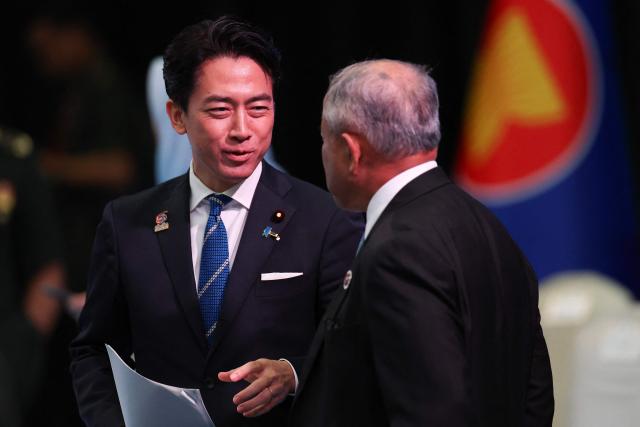 Japan's Defence Minister Shinjiro Koizumi (L) talks with Brunei's Defence Minister Halbi bin Haji Mohd Yussof (R) during the ASEAN-Japan Defence Ministers' Informal Meeting at the Association of Southeast Asian Nations (ASEAN) Defence Ministers' Meeting in Kuala Lumpur on November 1, 2025. (Photo by FAZRY ISMAIL / POOL / AFP)