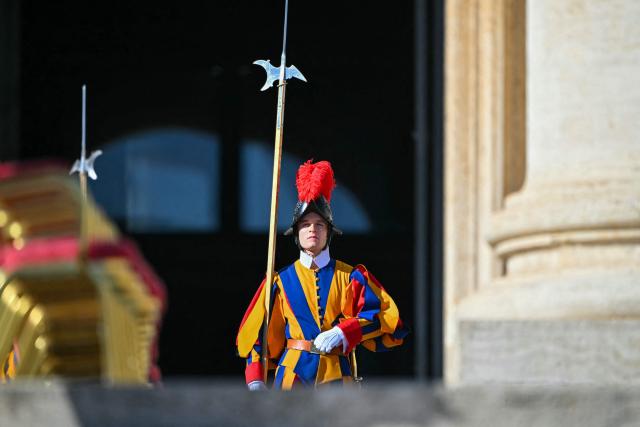 A Swiss Guard marches prior to the Solemnity of All Saints with the Rite of Proclamation of Saint John Henry Newman as a "Doctor of the Church" on the occasion of the Jubilee of the World Education on All Saints' Day at St. Peter's square, in The Vatican on November 1, 2025. (Photo by Andreas SOLARO / AFP)