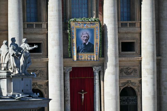 A portrait of Saint John Henry Newman is hanged on St Peter's basilica during the Solemnity of All Saints with the Rite of Proclamation of Saint John Henry Newman as a "Doctor of the Church" on the occasion of the Jubilee of the World Education on All Saints' Day at St. Peter's square, in The Vatican on November 1, 2025. (Photo by Andreas SOLARO / AFP)