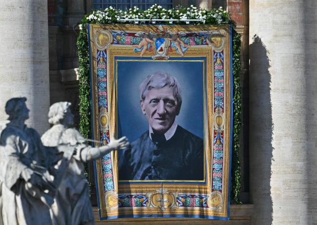 A portrait of Saint John Henry Newman is hanged on St Peter's basilica during the Solemnity of All Saints with the Rite of Proclamation of Saint John Henry Newman as a "Doctor of the Church" on the occasion of the Jubilee of the World Education on All Saints' Day at St. Peter's square, in The Vatican on November 1, 2025. (Photo by Andreas SOLARO / AFP)