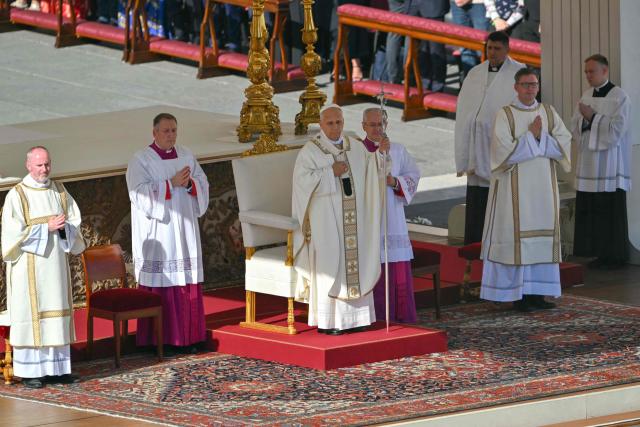 Pope Leo XIV (C) gestures as he leads the mass during the Solemnity of All Saints with the Rite of Proclamation of Saint John Henry Newman as a "Doctor of the Church" on the occasion of the Jubilee of the World Education on All Saints' Day at St. Peter's square, in The Vatican on November 1, 2025. (Photo by Andreas SOLARO / AFP)