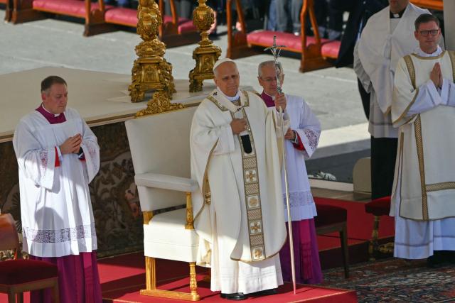 Pope Leo XIV (C) gestures as he leads the mass during the Solemnity of All Saints with the Rite of Proclamation of Saint John Henry Newman as a "Doctor of the Church" on the occasion of the Jubilee of the World Education on All Saints' Day at St. Peter's square, in The Vatican on November 1, 2025. (Photo by Andreas SOLARO / AFP)