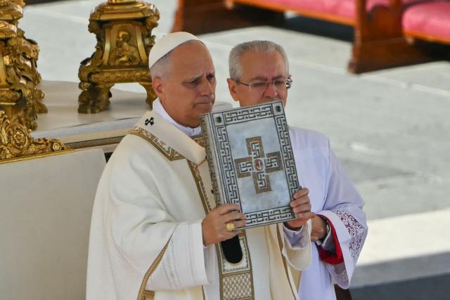 Pope Leo XIV (L) gestures as he leads the mass during the Solemnity of All Saints with the Rite of Proclamation of Saint John Henry Newman as a "Doctor of the Church" on the occasion of the Jubilee of the World Education on All Saints' Day at St. Peter's square, in The Vatican on November 1, 2025. (Photo by Andreas SOLARO / AFP)