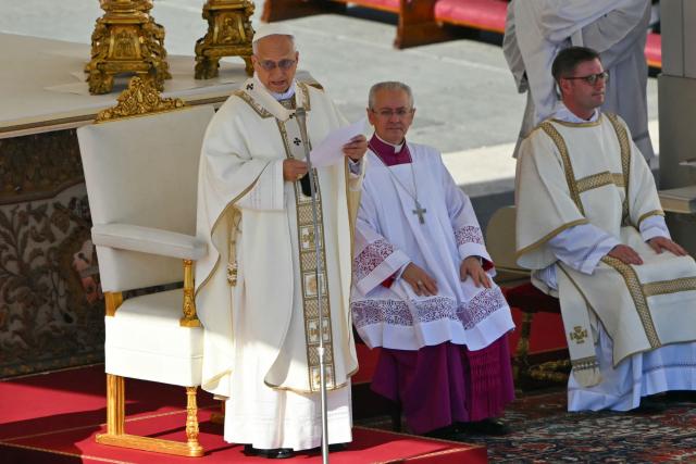 Pope Leo XIV (L) gestures as he leads the mass during the Solemnity of All Saints with the Rite of Proclamation of Saint John Henry Newman as a "Doctor of the Church" on the occasion of the Jubilee of the World Education on All Saints' Day at St. Peter's square, in The Vatican on November 1, 2025. (Photo by Andreas SOLARO / AFP)