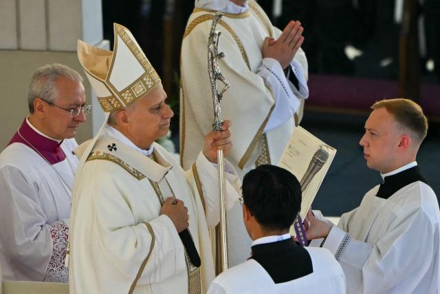 Pope Leo XIV (L) gestures as he leads the mass during the Solemnity of All Saints with the Rite of Proclamation of Saint John Henry Newman as a "Doctor of the Church" on the occasion of the Jubilee of the World Education on All Saints' Day at St. Peter's square, in The Vatican on November 1, 2025. (Photo by Andreas SOLARO / AFP)