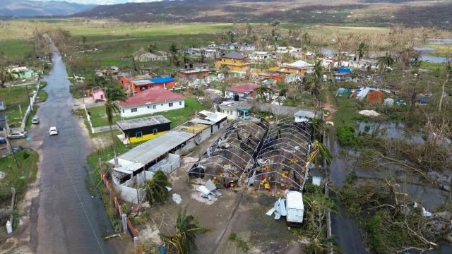 Flooding and damaged buildings are seen in the aftermath of Hurricane Melissa in Lacovia, St Elizabeth, Jamaica, on October 31, 2025. At least 19 people in Jamaica have died as a result of Hurricane Melissa which devastated the island nation when it roared ashore this week, a government minister told news outlets late October 31. (Photo by Ricardo Makyn / AFP)