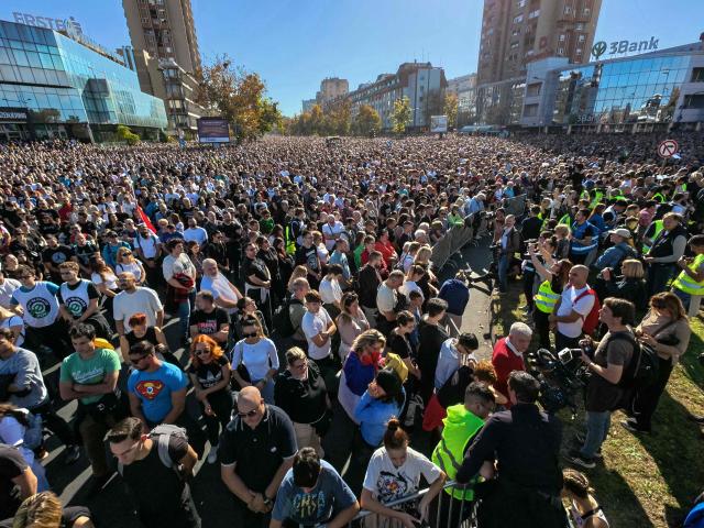 Attendees observe 16 minutes of silence during a gathering marking the first anniversary of the Novi Sad railway station tragedy, in Novi Sad, on November 1, 2025. Tens of thousands gather in Serbia's second largest city Novi Sad to commemorate victims of a railway station collapse a year ago that triggered mass protests. On November 1, 2024, the collapse of the canopy at the newly-renovated railway station in Novi Sad killed 16 people. Regular student-led protests have gripped the Balkan nation since the tragedy, which became a symbol of entrenched corruption. (Photo by Andrej ISAKOVIC / AFP)
