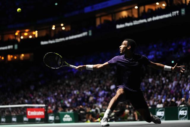 Canada's Felix Auger-Aliassime plays a backhand return to Kazakhstan's Alexander Bublik during their men's singles semi-final match on day six of the Paris ATP Masters 1000 tennis tournament at the Paris La Défense Arena in Nanterre, on the outskirts of Paris, on November 1, 2025. (Photo by Dimitar DILKOFF / AFP)