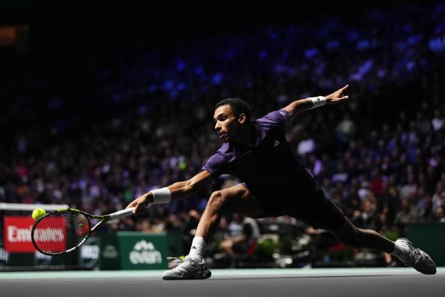 Canada's Felix Auger-Aliassime plays a backhand return to Kazakhstan's Alexander Bublik during their men's singles semi-final match on day six of the Paris ATP Masters 1000 tennis tournament at the Paris La Défense Arena in Nanterre, on the outskirts of Paris, on November 1, 2025. (Photo by Dimitar DILKOFF / AFP)