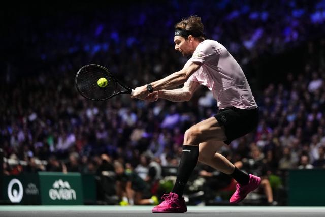 Kazakhstan's Alexander Bublik plays a backhand return to Canada's Felix Auger-Aliassime during their men's singles semi-final match on day six of the Paris ATP Masters 1000 tennis tournament at the Paris La Défense Arena in Nanterre, on the outskirts of Paris, on November 1, 2025. (Photo by Dimitar DILKOFF / AFP)