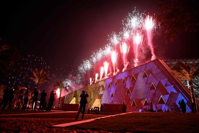 Fireworks light up the sky during the opening ceremony of the Grand Egyptian Museum (GEM) in Giza, on the southwestern outskirts of the capital Cairo on November 1, 2025. Near the ancient Pyramids of Giza just outside Cairo, the Grand Egyptian Museum is gearing up for a lavish opening on November 1, after two decades of delays. Massive statues and historic artefacts from the country's ancient civilisation will be on display across the 24,000 square metres (258,000 square feet) of permanent exhibition space. (Photo by Khaled DESOUKI / AFP)