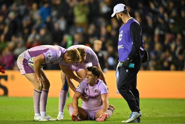 Scotland's fly-half Adam Hastings (C) is checked on after suffering a knock during the Autumn Nations Series international rugby union match between Scotland and USA at Murrayfield in Edinburgh on November 1, 2025. (Photo by ANDY BUCHANAN / AFP)
