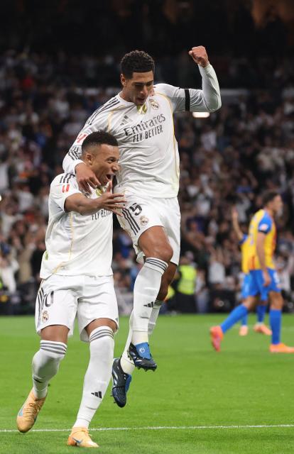 Real Madrid's French forward #10 Kylian Mbappe celebrates scoring the opening goal with Real Madrid's English midfielder #05 Jude Bellingham (R) during the Spanish League football match between Real Madrid CF and Valencia CF at Santiago Bernabeu Stadium in Madrid on November 1, 2025. (Photo by Oscar DEL POZO / AFP)