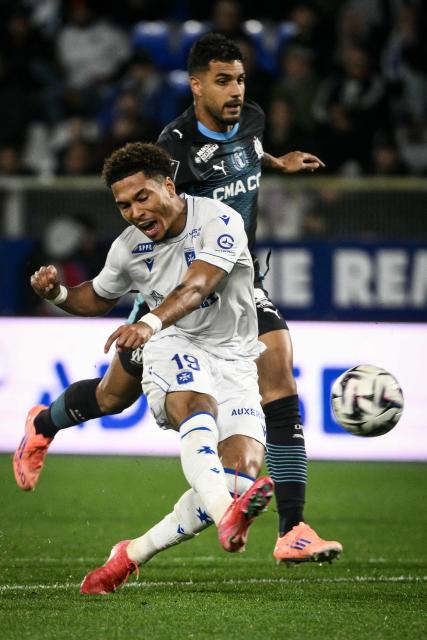 Auxerre's Cameroonian forward #19 Danny Namaso and Marseille's Italian defender #33 Emerson Palmieri fight for the ball during the French L1 football match AJ Auxerre versus Olympique de Marseille (OM) at the Abbe Deschamps stadium in Auxerre, eastern France on November 1, 2025. (Photo by ARNAUD FINISTRE / AFP)