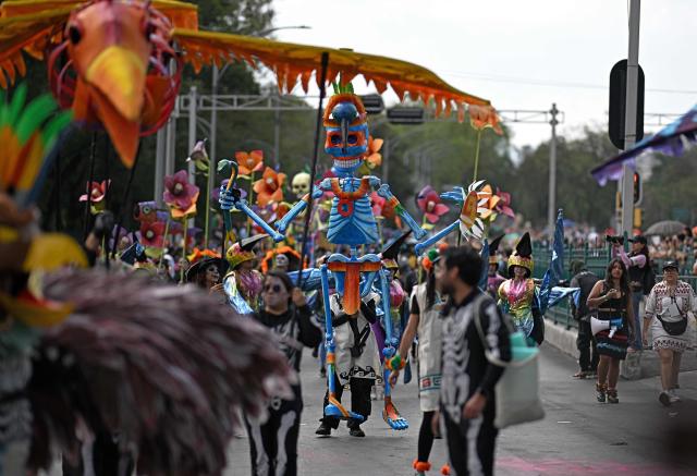 Revellers attend the Grand Parade commemorating the Day of the Dead in Mexico City, on November 1, 2025. (Photo by CARL DE SOUZA / AFP)