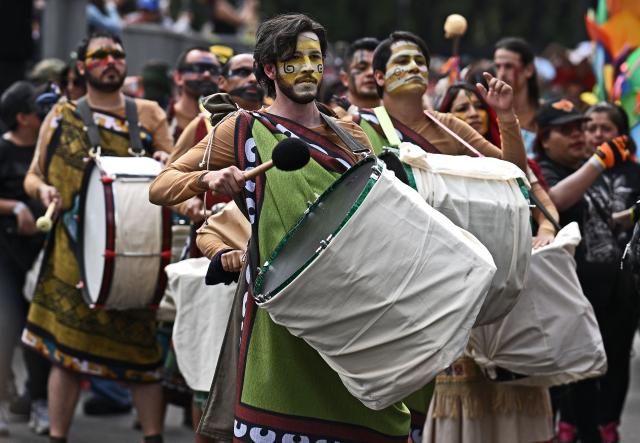 Revellers attend the Grand Parade commemorating the Day of the Dead in Mexico City, on November 1, 2025. (Photo by CARL DE SOUZA / AFP)