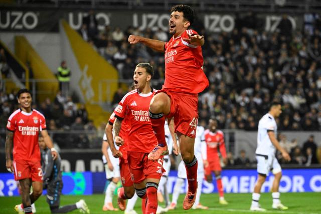 SL Benfica's Portuguese defender #44 Tomas Araujo celebrates scoring his team's first goal  during the Portuguese League football match between Vitoria Guimaraes SC and SL Benfica at Dom Afonso Henriques stadium in Guimaraes on November 1, 2025. (Photo by Miguel RIOPA / AFP)