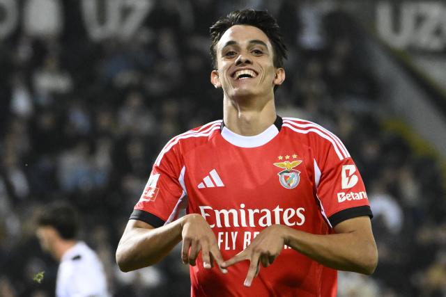 SL Benfica's Portuguese forward #84 Joao Rego celebrates scoring his team's third goal during the Portuguese League football match between Vitoria Guimaraes SC and SL Benfica at Dom Afonso Henriques stadium in Guimaraes on November 1, 2025. (Photo by Miguel RIOPA / AFP)