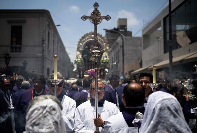 Catholic faithfuls attend the traditional Lord of Miracles procession in Lima on November 1, 2025. (Photo by ERNESTO BENAVIDES / AFP)