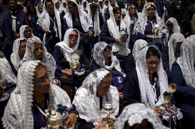 Catholic faithfuls attend the traditional Lord of Miracles procession in Lima on November 1, 2025. (Photo by ERNESTO BENAVIDES / AFP)