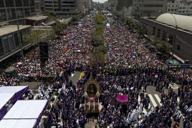 Aerial view as Catholic devotes attend the traditional Lord of Miracles procession in Lima on November 1, 2025. (Photo by CARL DE SOUZA / AFP)