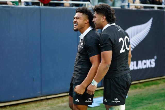 New Zealand's Leicester Fainga'anuku (L) celebrates with Wallace Sititi (R) team's win against Ireland after the "Gallagher Cup" international rugby test match at Soldier Field in Chicago, Illinois, on November 1, 2025. (Photo by KAMIL KRZACZYNSKI / AFP)