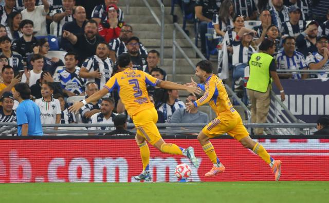 Tigres' Argentine forward #07 Angel Correa (R) celebrates after scoring the equalisinf goal with teammate Tigres' US defender #03 Marco Farfan during the Liga MX Apertura football tournament match between Monterrey and Tigres at BBVA Stadium in Monterrey, Mexico on November 1, 2025. (Photo by Julio Cesar AGUILAR / AFP)