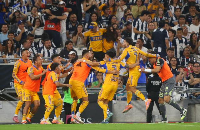 Tigres' Argentine forward #07 Angel Correa celebrates with teammates after scoring the equalising goal during the Liga MX Apertura football tournament match between Monterrey and Tigres at BBVA Stadium in Monterrey, Mexico on November 1, 2025. (Photo by Julio Cesar AGUILAR / AFP)
