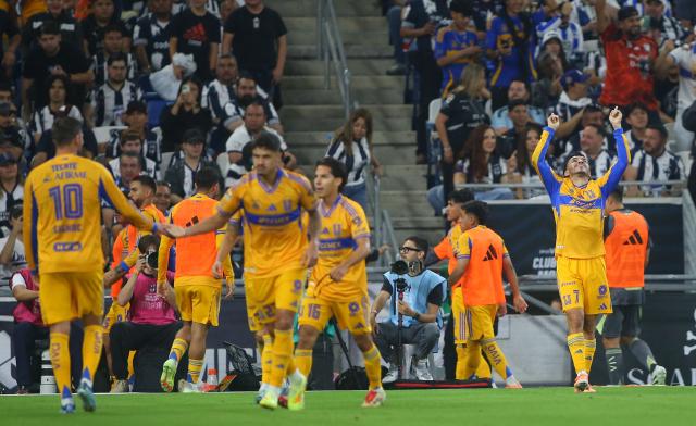 Tigres' Argentine forward #07 Angel Correa celebrates with teammates after scoring the equalising goal during the Liga MX Apertura football tournament match between Monterrey and Tigres at BBVA Stadium in Monterrey, Mexico on November 1, 2025. (Photo by Julio Cesar AGUILAR / AFP)