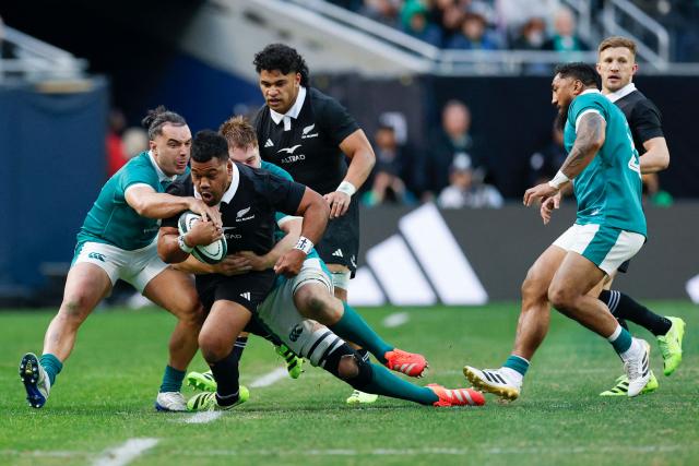 Ireland's Iain Henderson (19) tackles New Zealand's Samisoni Taukei'aho (16) during the second half of the "Gallagher Cup" international rugby test match at Soldier Field in Chicago, Illinois, on November 1, 2025. (Photo by KAMIL KRZACZYNSKI / AFP)