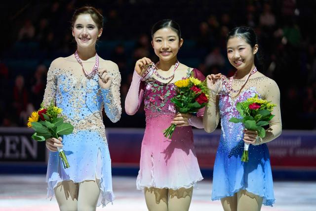 Gold medalist Mone Chiba of Japan (C) poses with silver medalist Isabeau Levito of the United States (L) and Ami Nakai of Japan during the victory ceremony for the women’s competition during the ISU Grand Prix of Figure Skating 2025 Skate Canada International at the SaskTel Centre in Saskatoon, Saskatchewan, Canada on November 1, 2025. (Photo by Geoff Robins / AFP)