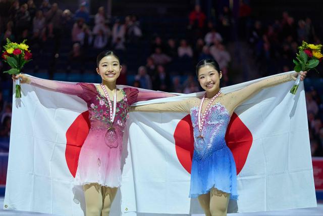 Gold medalist Mone Chiba of Japan (L) poses with bronze medalist Ami Nakai of Japan during the victory ceremony for the women’s competition during the ISU Grand Prix of Figure Skating 2025 Skate Canada International at the SaskTel Centre in Saskatoon, Saskatchewan, Canada on November 1, 2025. (Photo by Geoff Robins / AFP)
