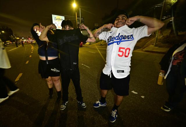 Dodgers fans celebrate in the street after their team won Game 7 of the World Series against the Toronto Blue Jays, in Los Angeles on November 1, 2025. (Photo by Frederic J. Brown / AFP)