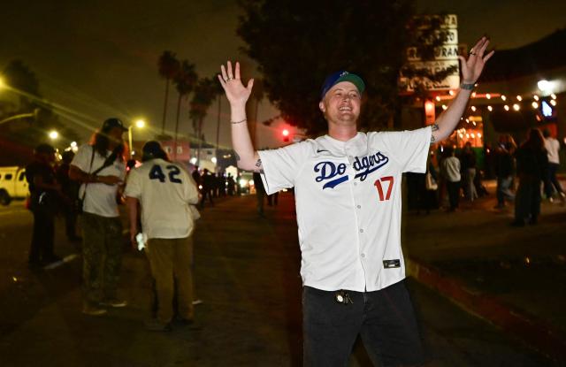 Dodgers fans celebrate in the street after their team won Game 7 of the World Series against the Toronto Blue Jays, in Los Angeles on November 1, 2025. (Photo by Frederic J. Brown / AFP)