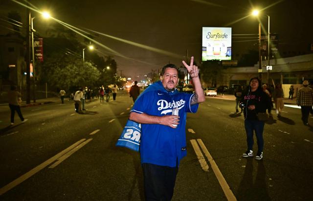 Dodgers fans celebrate in the street after their team won Game 7 of the World Series against the Toronto Blue Jays, in Los Angeles on November 1, 2025. (Photo by Frederic J. Brown / AFP)