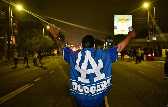 Dodgers fans celebrate in the street after their team won Game 7 of the World Series against the Toronto Blue Jays, in Los Angeles on November 1, 2025. (Photo by Frederic J. Brown / AFP)