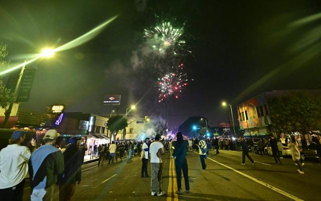 Dodgers fans celebrate in the street after their team won Game 7 of the World Series against the Toronto Blue Jays, in Los Angeles on November 1, 2025. The Los Angeles Dodgers defeated the Toronto Blue Jays 5-4 to become the first team in 25 years to win back-to-back World Series in an extra-innings game seven thriller on November 1. (Photo by Frederic J. Brown / AFP)