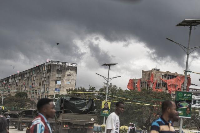 Civilians cross a road as a column of Tanzanian soldiers drives past electoral posters of the ruling Chama Cha Mapinduzi (CCM) presidential candidates and incumbent Tanzanian President Samia Suluhu Hassan and Zanzibar President Hussein Ali Mwinyi in Stone Town on October 30, 2025. Tanzania was on lockdown with a communications blackout from October 30, 2025, a day after elections turned into violent chaos with unconfirmed reports of many dead.
President Samia Suluhu Hassan had sought to solidify her position and silence criticism within her party in the virtually uncontested polls, with the main challengers either jailed or disqualified. (Photo by MARCO LONGARI / AFP)