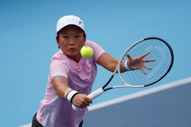 Jiang Xinyu of China hits a return against Momoko Kobori of Japan and Peangtarn Plipuech of Thailand during the women's doubles final match in the Hong Kong Tennis Open in Hong Kong on November 2, 2025 (Photo by May James / AFP)