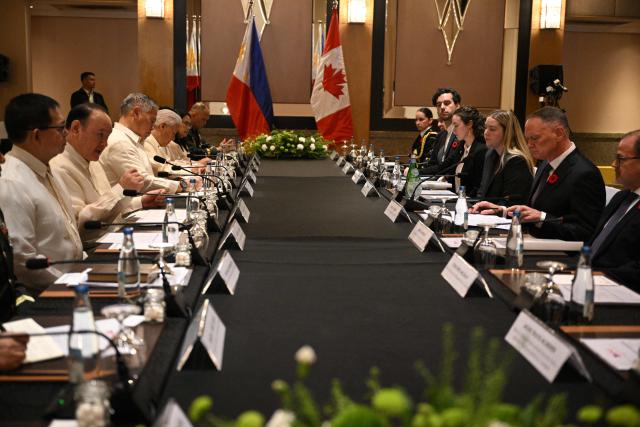 Philippines' Secretary of National Defence Gilberto Teodoro (3rd L) speaks while Canadian Minister of Defence David McGuinty (2nd R) listens during their bilateral meeting in Manila on November 2, 2025.  (Photo by Ted ALJIBE / AFP)