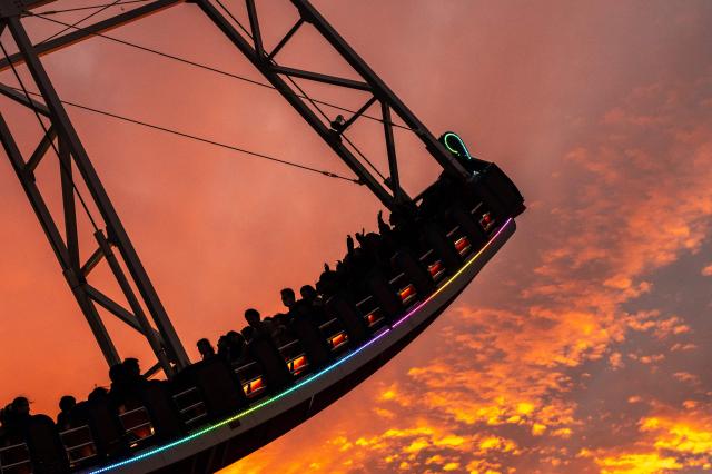 People ride on a pirate ship amusement ride at the Tokyo Dome City during evening hour in Bunkyo district of Tokyo on November 2, 2025. (Photo by Philip FONG / AFP)