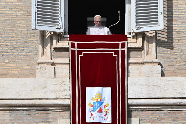 Pope Leo XIV appears at the window of the apostolic palace overlooking St. Peter's square during the Angelus prayer in The Vatican on November 2, 2025. (Photo by Andreas SOLARO / AFP)