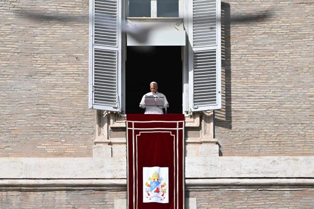 Pope Leo XIV addresses the audience from the window of the apostolic palace overlooking St. Peter's square during the Angelus prayer in The Vatican on November 2, 2025. (Photo by Andreas SOLARO / AFP)