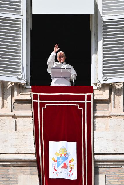 Pope Leo XIV blesses the crowd from the window of the apostolic palace overlooking St. Peter's square during the Angelus prayer in The Vatican on November 2, 2025. (Photo by Andreas SOLARO / AFP)