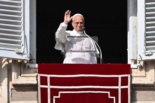 Pope Leo XIV waves to the crowd from the window of the apostolic palace overlooking St. Peter's square during the Angelus prayer in The Vatican on November 2, 2025. (Photo by Andreas SOLARO / AFP)