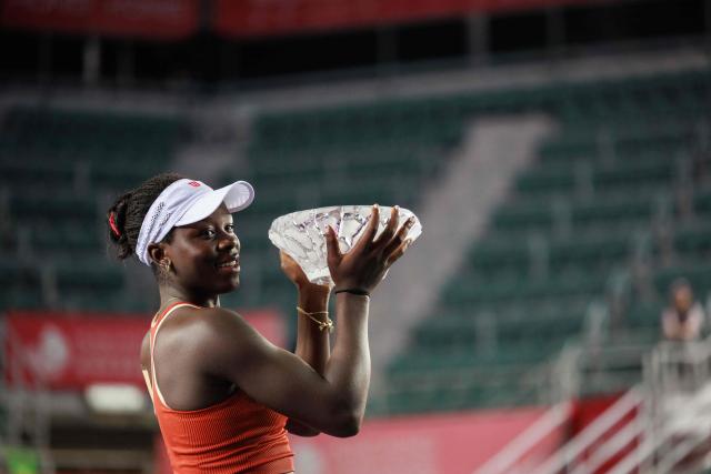 Victoria Mboko of Canada holds the trophy after winning against Cristina Bucsa of Spain in the women's singles final of the Hong Kong Tennis Open in Hong Kong on November 2, 2025. (Photo by May James / AFP)