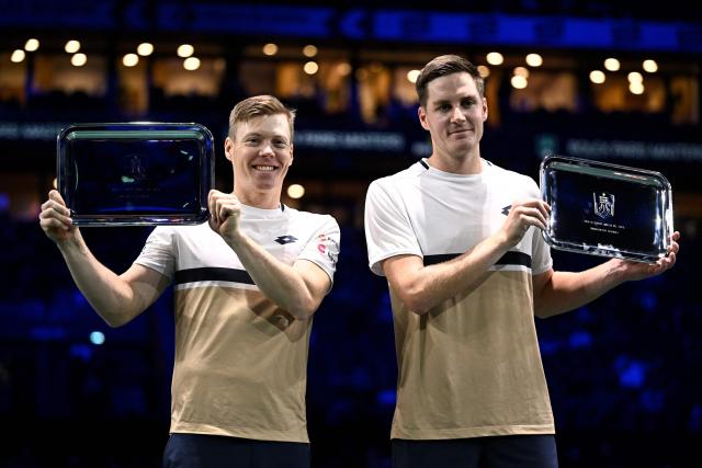 Finland's Harri Heliovaara (L) and Britain's Henry Patten celebrate with the trophy after winning against Britain's Julian Cash and Britain's Lloyd Glasspool at the end of the men's doubles final match on day seven of the Paris ATP Masters 1000 tennis tournament at the Paris La Défense Arena in Nanterre, on the outskirts of Paris, on November 2, 2025. (Photo by JULIEN DE ROSA / AFP)