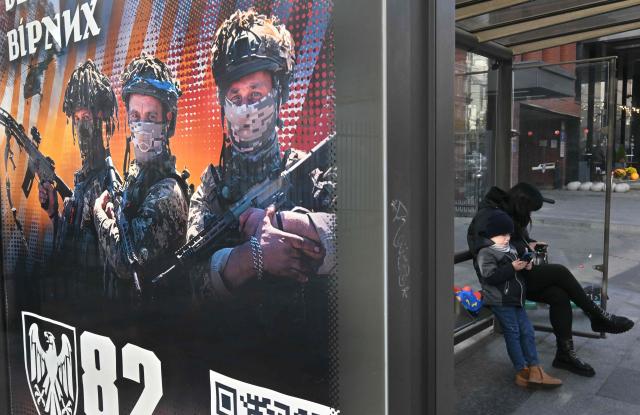 This photograph shows a recruiting placard of the 82 separate assault brigade which reads "Join the fearless and faithful" at a bus stop in Kyiv on November 2, 2025, amid the Russian invasion of Ukraine. (Photo by Sergei SUPINSKY / AFP)