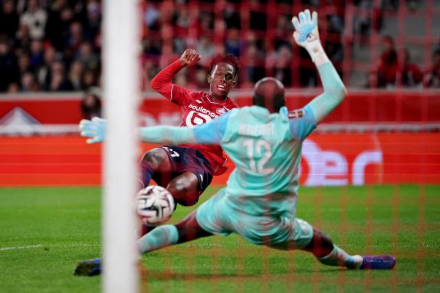 TOPSHOT - Lille's Portuguese forward #27 Felix Correia (L) scores his team's first goal during the French L1 football match between LOSC Lille and Angers SCO at Stade Pierre-Mauroy in Villeneuve-d'Ascq, near Lille on November 2, 2025. (Photo by Anne-Christine POUJOULAT / AFP)