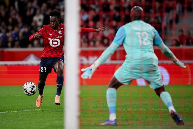 Lille's Portuguese forward #27 Felix Correia (L) shoots to score his team's first goal during the French L1 football match between LOSC Lille and Angers SCO at Stade Pierre-Mauroy in Villeneuve-d'Ascq, near Lille on November 2, 2025. (Photo by Anne-Christine POUJOULAT / AFP)